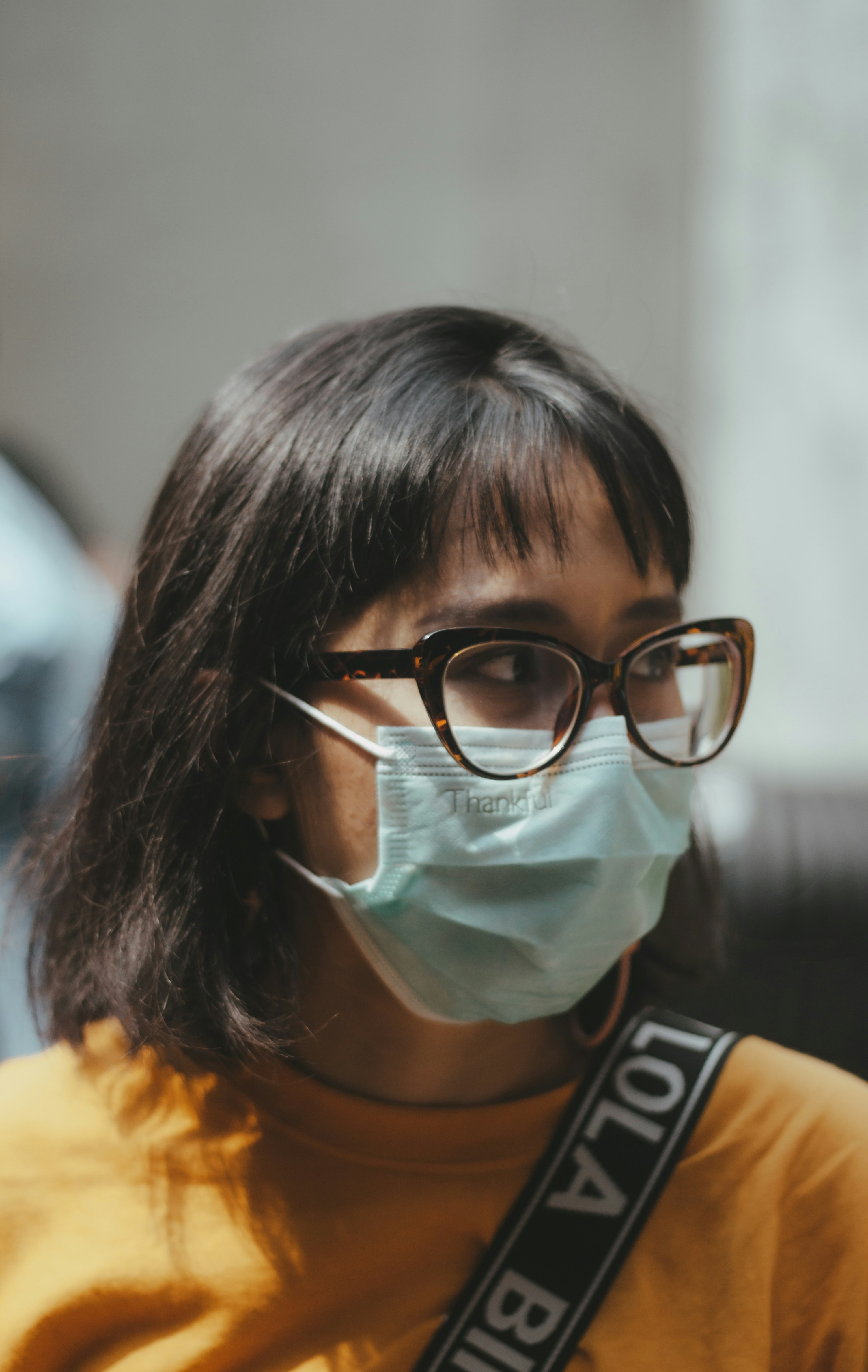 woman in black and white stripe shirt wearing eyeglasses